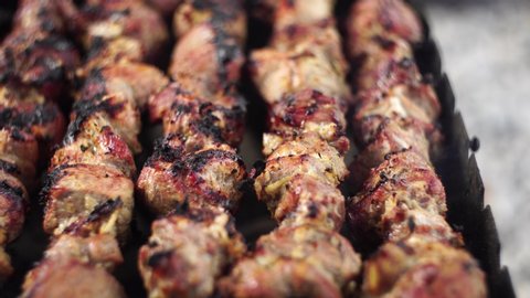 Ready shish kebabs on the grill.Barbecue on the grill. Very juicy fresh. BBQ Marinated shashlik preparing on a barbecue grill over charcoal. Shashlyk skewered meat was originally made of lamb.