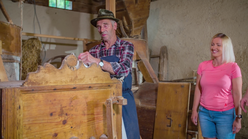 Local Farmer Giving Gifts To Young Couple Visiting Povhov Mill. Slow Motion, Follow Shot