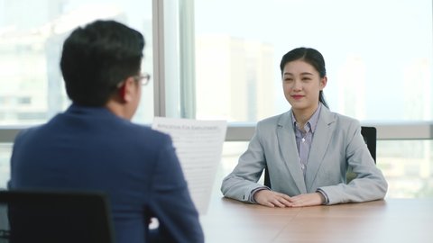 young asian business woman corporate executive being interviewed by HR manager in modern corporation