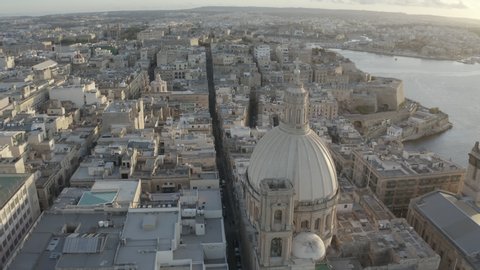 Scenic drone panorama in valletta malta with church cathedral during sunset 