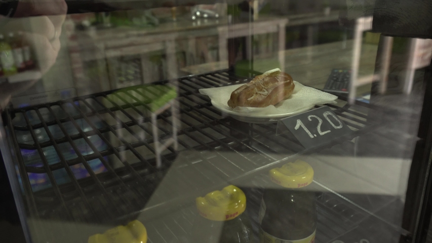 Sweets are sold in the store on a display window croissants, cakes and muffins, background