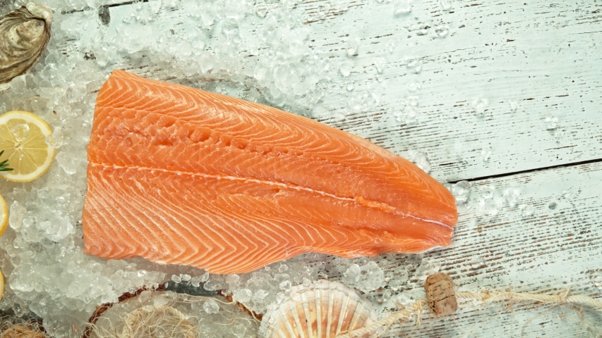 Super Slow Motion Shot of Falling Big Fresh Salmon Steak into Crushed Ice. | Shutterstock HD Video #1056209885