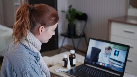 modern medicine, young woman with poor health consults with an online doctor about the diagnosis and medical preparations while sitting at laptop in bed in room