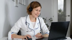 Woman doctor wear uniform with stethoscope talk by conference video call, consult patient online, distant medical consultation in internet