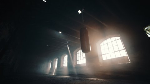 Punching bag in a deserted room up-angle	
