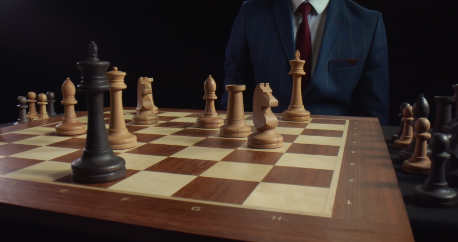 Close up of businessman moving white king defeating black king of opponent during chess game. Competition, leadership and checkmate concept Royalty-Free Stock Footage #1056223028
