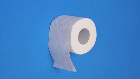 Roll of toilet paper on a blue background. Stop motion animation