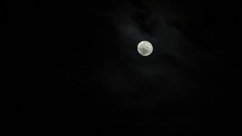 Full moon behind moving clouds. Great for Werewolves or vampires during Halloween.