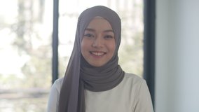 Portrait of successful beautiful executive businesswoman casual wear looking at camera and smile, happy in modern office workplace. Young Asia muslim lady stand relax in contemporary coworking space. - Powered by Shutterstock - Get 15% off with code: PIKWIZARD15