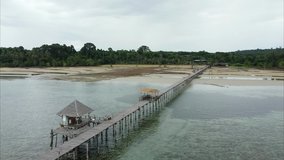 Beautiful aerial view of The dreaming bridge. Longest wooden bridge that go into the sea on Koh Mak, Trat, Thailand. (2.7k Video resolution by drone)