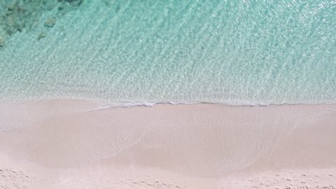 Aerial Drone Top-Down Zenithal still view of pink sand beach and turquoise water, Ibiza, Formentera, Spain