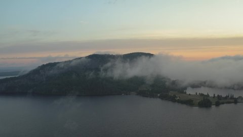 Sunrise fog surrounding Mount Kineo over Moosehead Lake aerial