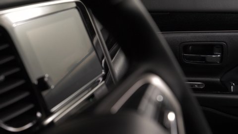 Panning of the interior of a luxury car with leather upholstery doors and seats
