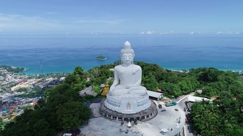 Aerial view Drone camera video of White Marble Big Buddha Statue Temple on highest mountain Beautiful landmark in Phuket Thailand