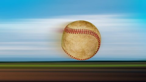 speed of one old leather baseball flying and rotating in the air on nature background