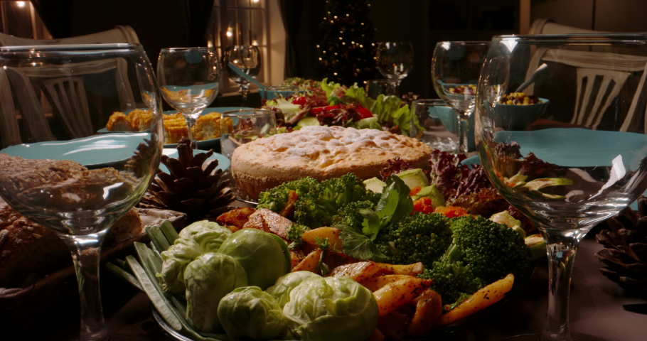 Family holiday dinner table set with healthy organic nutritious meals. Party table set for celebration together - close up shot holidays, food and drink concept 4k footage Royalty-Free Stock Footage #1056257171