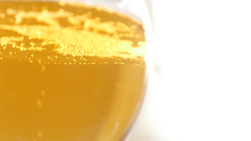 Slow tilt on glass full of beer 4K 3840X2160 UltraHD footage - Bubbles and foam in glass of beer 4K 2160p UHD video Royalty-Free Stock Footage #10562579