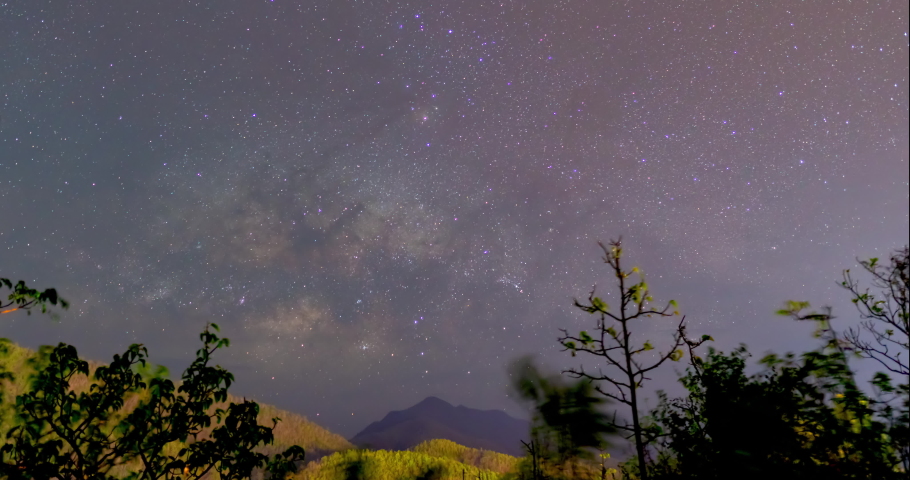 Milky Way Galaxy Time Lapse above the mountain forest from a dark night to a bright by moonlight at Mae Hong Son amazing Thailand with jib effect.  