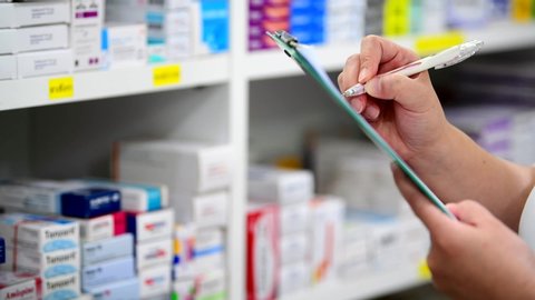 Pharmacist filling prescription in pharmacy drugstore	