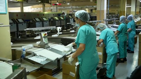 Chelyabinsk, chelyabinsk region / Russia - 07.20.2020: poultry workers are packing eggs into boxes.

Workers in special protective uniforms pack products from the conveyor.
