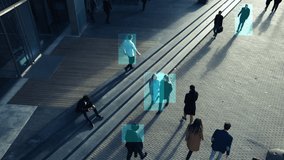 Elevated Security Camera Surveillance Footage of a Crowd of People Walking on Busy Urban City Streets. CCTV AI Facial Recognition Big Data Analysis Interface Scanning, Showing Animated Information