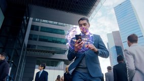 Handsome Businessman Uses Smartphone with Animated Infographics Showing Internet Icons, Walks through Crowded City Streets. Big Data, Information, e-Business Concept. Moving Low Angle Front View - Powered by Shutterstock - Get 15% off with code: PIKWIZARD15