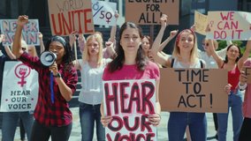 Portrait of woman with poster participating in female demonstration. Active strong girls protesting against women discrimination. Gender equality. Strike. - Powered by Shutterstock - Get 15% off with code: PIKWIZARD15