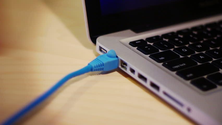 Plugging and unplugging a network cable on a laptop computer.
