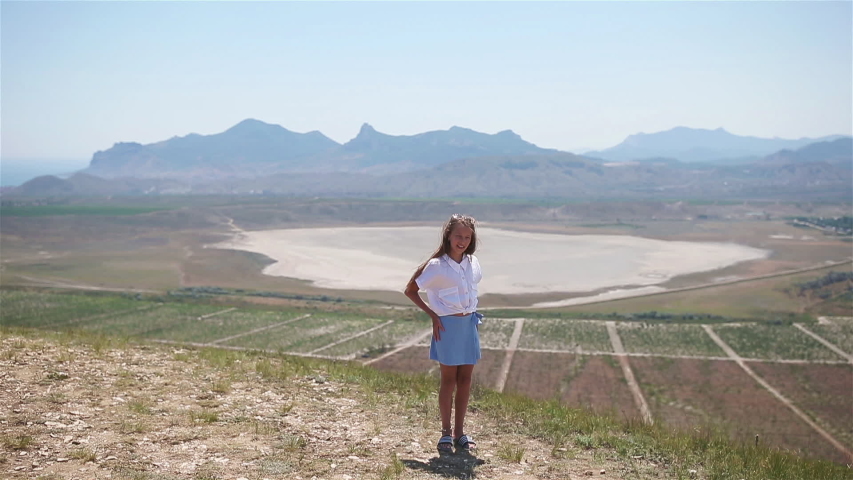 Beautiful girl standing near the lake on the mountain. Concept of european vacation.