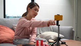 Cheerful Asian female blogger is reviewing cosmetic products and teaching them how to make up, Beauty blogger, Live streaming.