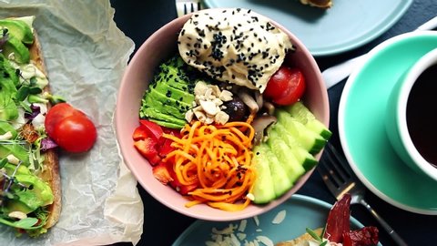 Healthy breakfast meal video clip.Delicious avocado toast,poke bowl,coffee cup served for lunch in vegetarian cafe.Enjoy good nutrition with natural foods with low fats.Tasty dinner in restaurant
