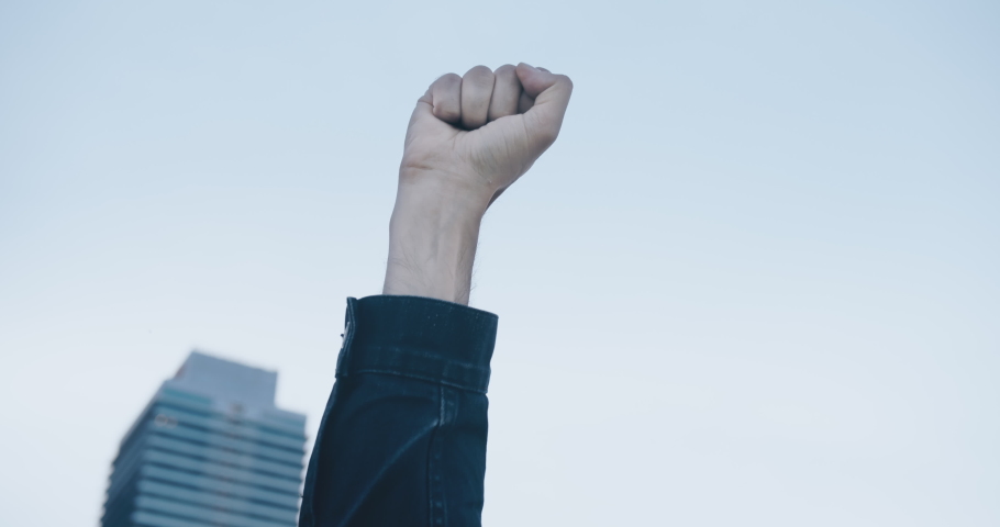 Raised white man's fist in protest at demostration protest. Social justice and peaceful protesting racial injustice Royalty-Free Stock Footage #1056284846