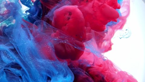 Blue and red mixing in water on white background, Slow motion.