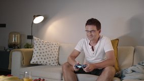 Slomo: Excited Handsome Caucasian Man Playing Video Games On A Console And Winning 