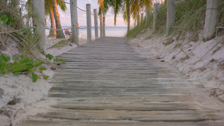 Palm tree lined pathway to the Smathers Beach in tropical Key West Florida USA