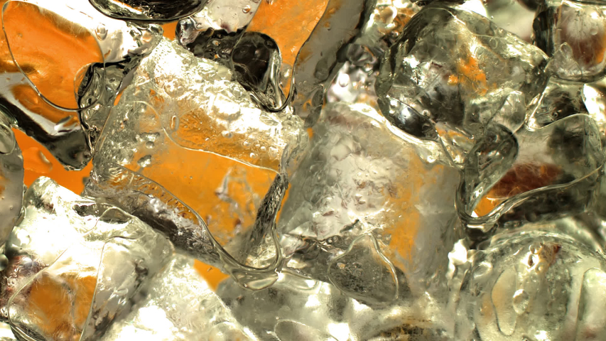 The beautiful golden liquid is running through the ice cubes in a cocktail glass. Dramatic close-up and extreme slow motion. Works for cider, beer, prosecco, pink wine, juice, rum, liquor, whiskey. 
 Royalty-Free Stock Footage #1056292478