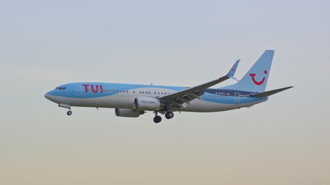 BARCELONA, SPAIN - 2020: TUI TUIfly Boeing 737-800 Jet Airliner Early Morning Arrival Flying into Barcelona-El Prat BCN International Airport from a Vibrant Colorful Sky Landing and Touching Down