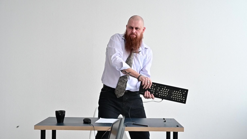 Angry businessman breaking a keyboard on monitor in the office. man has a tantrum from a problem at work. manager freaks out and breaks the computer. | Shutterstock HD Video #1056299213