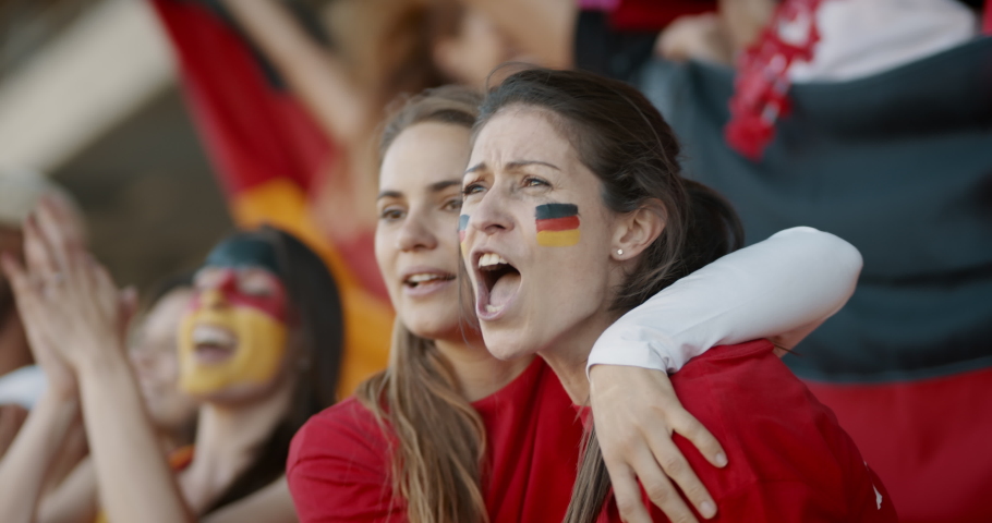 Best friends enjoying watching a soccer game. Two women with German flag painted in their faces watching a soccer game and cheering for their national team.
 Royalty-Free Stock Footage #1056301868