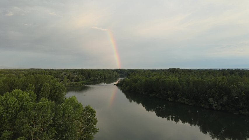 Aerial of Rainbow reflection on the Loire river with cloudy sky, France Europe