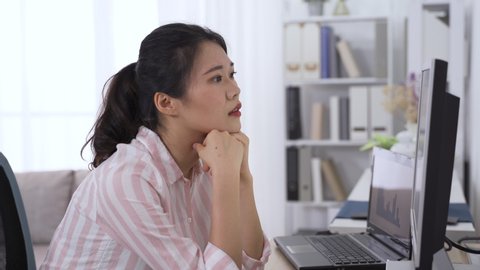 asian female supervisor troubled with eye fatigue let out a sigh. taiwanese lady propping head is having dry eyes while looking at data on computer. health and eye care concept