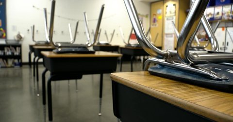 empty classroom with chairs on desks row