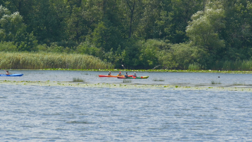 Kayaking on the river. A group of sportsmen tourists swim in kayaks on a summer day on the river. Travel Water Tourism Holiday Vacation