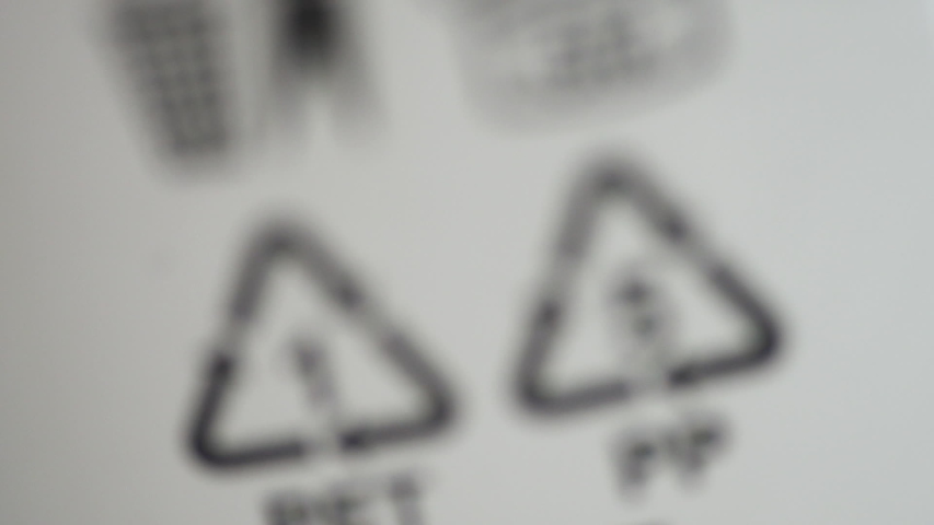 Closeup view of signs and symbols of recycling on white background packaging spbd. Eco labeling pet and PP is depicted on packages of products made of polypropylene. Concept: recycling, ecology | Shutterstock HD Video #1056326483
