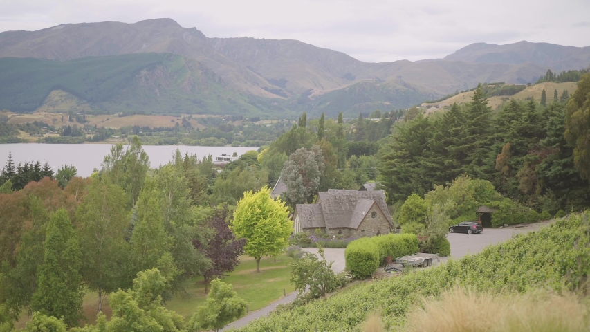 steady shot of stoneridge chapell chruch and lake hayes and the farm estate queenstown