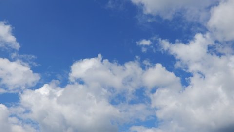 white clouds on blue background. time lapse