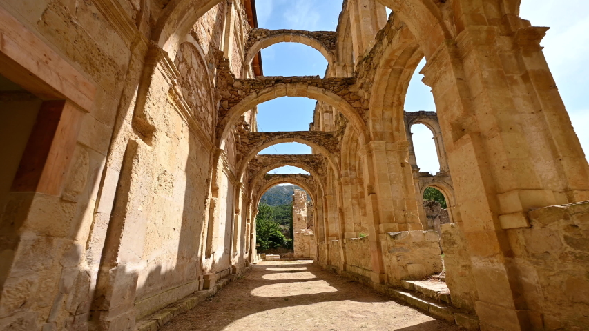 POV walking inside cloister ruins of an ancient abandoned Monastery Santa Maria De Rioseco, in Burgos, Spain. High quality 4k footage