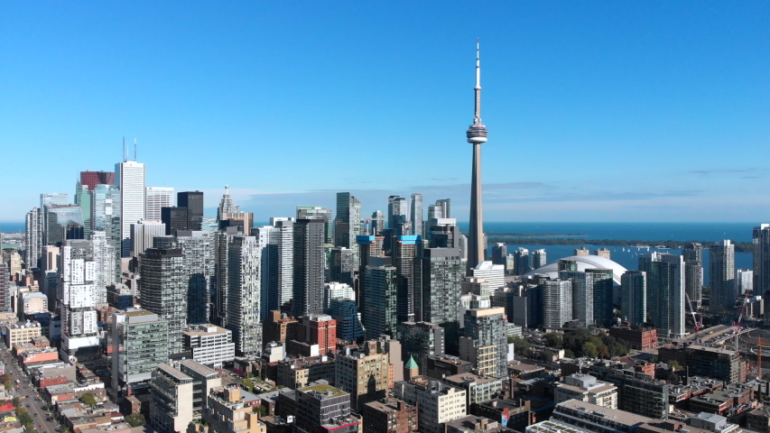 Aerial view of Toronto cityscape including architectural landmark CN Tower and high-rise buildings in the financial district on a sunny day, Ontario, Canada.  Royalty-Free Stock Footage #1056337664