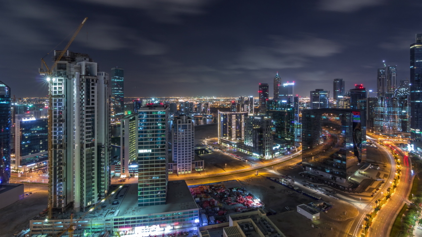 Aerial view of illuminated buildings timelapse during all night and high traffic on roads near canal. Night life in Business Bay, Dubai, United Arab Emirates | Shutterstock HD Video #1056338828