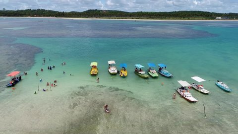 Porto de Galinhas beach, Brazil. Boats water. Beach natural pools. Aerial landscape of tropical beach bay. Paradise. Vacation travel. Tropical travel. People having fun. Exotic background. Beach life